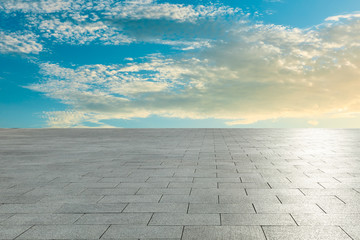 Empty square pavement and blue sky with white clouds