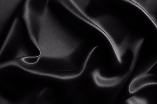 Satin black silk background, close-up