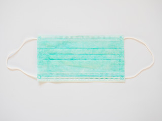 Blue surgical mask with rubber ear straps. Typical three-layer surgical mask for covering the mouth and nose. (Clipping path). Protection concept