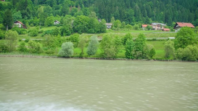 The village view from motorboat on the river Drava, Slovenia