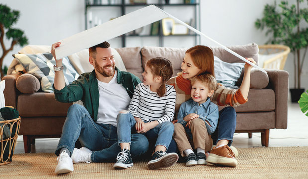 Concept Housing A Young Family. Mother Father And Children In  New Home.