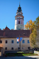 Obraz premium Flags of the Czech Republic and the European Union near an old building and church in autumn