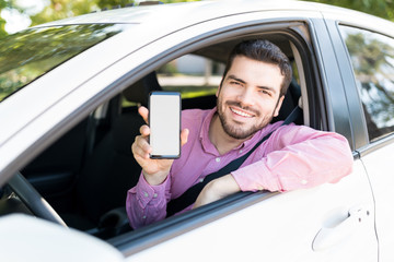 Smiling Handsome Man With Cellphone In Car