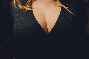 black short sweater with neckline female breast.