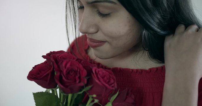 Couple in love with the most wonderful amazing red roses bouquet that smell heavenly as they are in love proposal for marriage to be his bride and he husband valentine's day slow-motion handheld 60fps