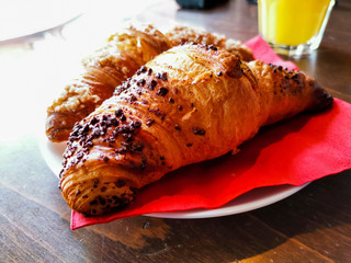 Delicious fresh croissant on table