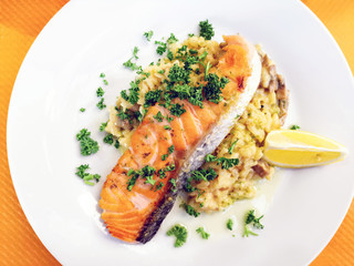 grilled salmon and lemon - french cuisine dish with tomato and salmon
