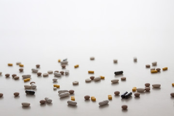 Scattered pills on a white background. Copy space. Nobody. Medicine.