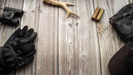 Hunting accessories on a wooden background, equipment. Hunting background. The concept of hunting.