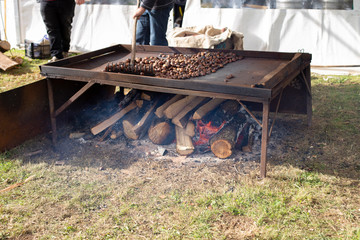 A man is roasting chestnuts - 322078166