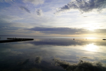 wood pontoon pier in blue night sunset in lake