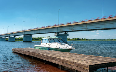 Fototapeta premium The small motorboat at the pier