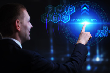 Business, Technology, Internet and network concept. Young businessman working on a virtual screen of the future and sees the inscription: Smart contract