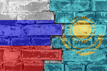 Russia Federation and Kazakhstan - National flags on Brick wall. Governments relations and conflict concept.