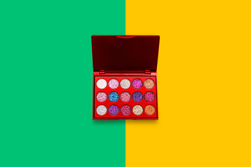 Eye shadow on a colored background. Women's cosmetic makeup accessory. Fashionable minimal design.