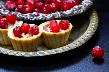 Still life with cranberry cakes on a blue background