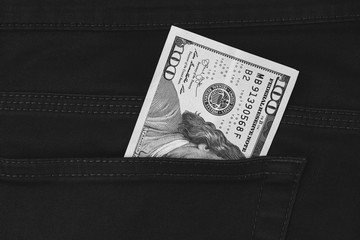 One hundred dollar banknote money in pocket trouser pants background texture. dollar bill close up