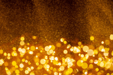 Christmas and Happy new year on blurred gold bokeh banner background.