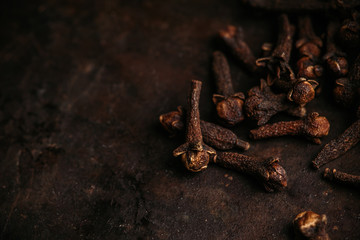 Dry cloves spices on the dark rustic background. Selective focus. shallow depth of field.