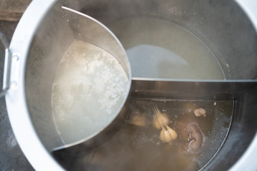 Stainless steel  pot with variety of hot soup for boiling noodle