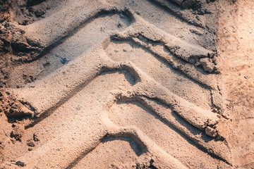 Deep tracks from the wheels of large truck on the sand in forest area.