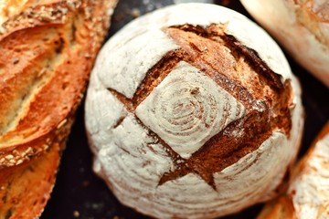Crispy bread on a dark background, top view. A variety of bread, place for text.
