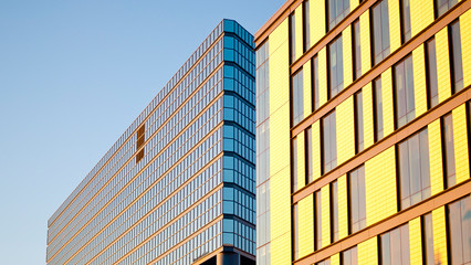 Facade of a random building in Calgary, Canada with glass and windows on a sunny winter day.