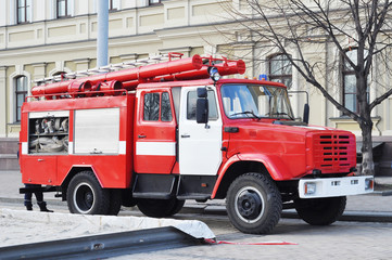 Red color firetruck ride on a call fire suppression on the street.