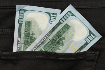 One hundred dollar banknote money in pocket trouser pants background texture. dollar bill close up