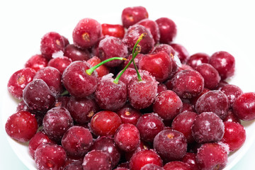 frozen fresh cherries on a white background. an ingredient for smoothies and smoothies. ice crystals on the berry. vertical photo. close up.