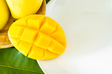 Ripe mango slice on white plate