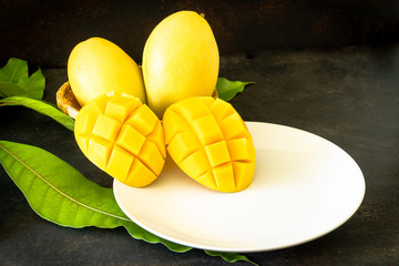 Ripe mango slice on white plate