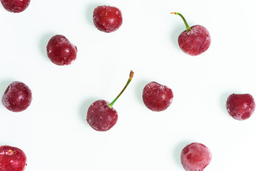 group of frozen cherries on a white background . the view from the top. ice crystals on the berry. vertical photo.