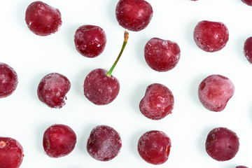 group of frozen cherries on a white background . the view from the top. ice crystals on the berry. vertical photo.