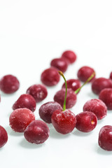 group of frozen cherries on a white background . ice crystals on the berry. vertical photo.
