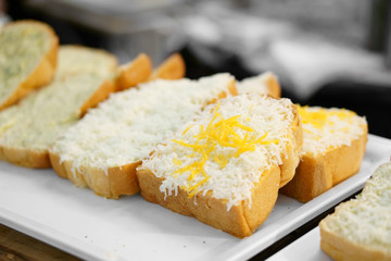 raw and fresh double cheese bread or toast white and yellow on tray and wood table for dessert or snack on breakfast for lunch and fast food in cafe restaurant and coffee shop or street bakery