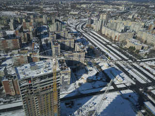 Lviv, Sychiv, Ukraine - 2 7 2020: Tower cranes work during the construction of a multi-story building. New apartments for residents and premises for offices. Risky work at height.