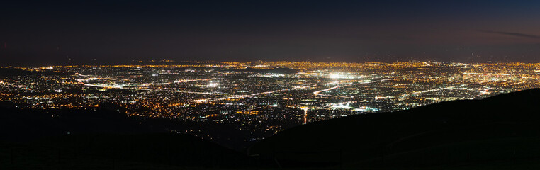 Panoramic night view of urban sprawl in San Jose, Silicon Valley, California; ; the downtown area buildings visible on the right