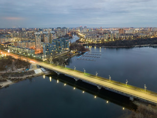 Obraz premium Aerial drone view. Automotive-subway bridge at dusk with backlight in Kiev.