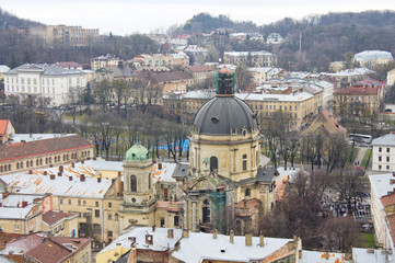 Fototapeta na wymiar The view from the heights of the rooftops of an old European city. Background for urban architecture. Europe.