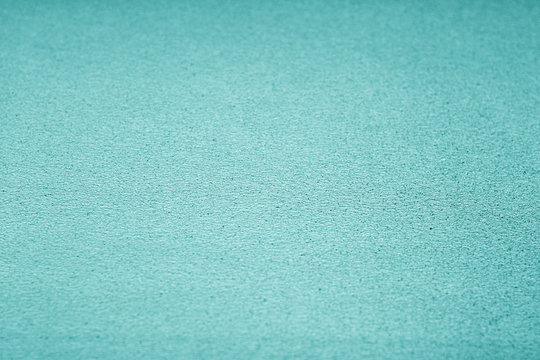Plastic glittering texture with blur effect in cyan tone.