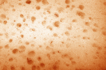 Cleaning sponge  surface close up in orange color.