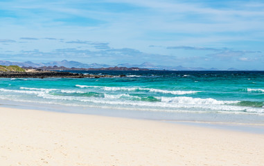 Fototapeta na wymiar Beach in Fuerteventura, one of Canary Islands. On the horizon there is Island of Lanzarote