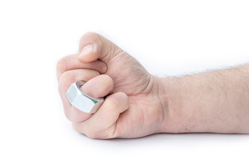 The human hand on the ring finger is wearing a nut like a wedding ring. Close-up. Separate on a white background