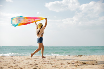 Happy traveler  asian woman  running on the beach  enjoys  her  tropical  vacation