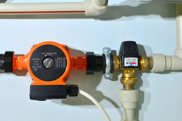 Pump with a thermometer for a water underfloor heating system at home. Sensor and temperature...