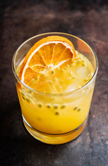 Old fahioned passion fruit cocktail on the rustic background. Selective focus. Shallow depth of field.