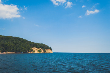 Naklejka premium Spectacular view on the island in the sea covered with forest and yellow sand