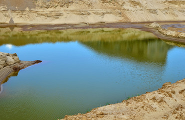 Sand and gravel washing production process in open-pit mining. Crushing the pebbles or ores,...