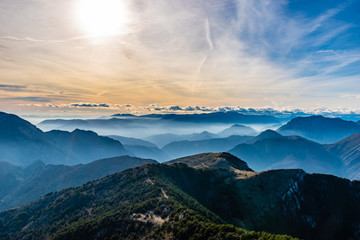 Beautiful captivating landscape of the layered misty hazy French Alps mountain range in...